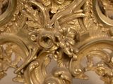 a gold clock that is sitting on a table