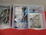 three bins filled with plastic items on a red table