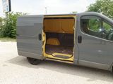 a grey van with its door open in a parking lot