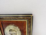 a clock that is hanging on the wall next to a wall