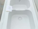a white sink sitting on top of a white counter