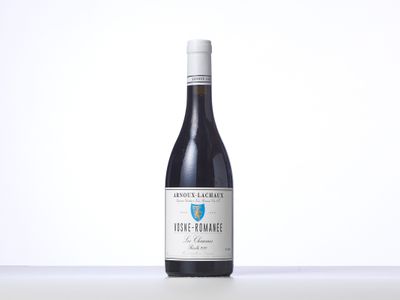 a bottle of red wine sitting on top of a table