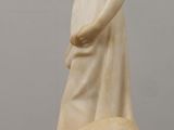 marble statue of a woman and a dog on a table