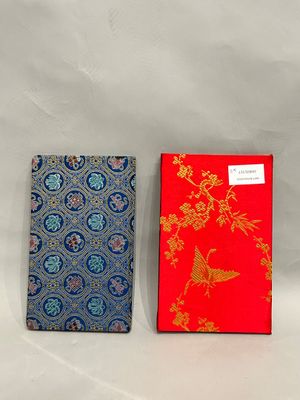two small notebooks sitting next to each other on a white surface