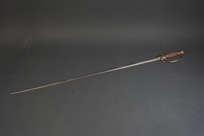 a close up of a knife on a table with a black background