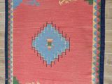 an image of a rug hanging on a wall in a room