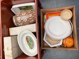 a box full of plates and bowls sitting on the floor