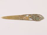 a close up of a metal spoon with a flower design on it