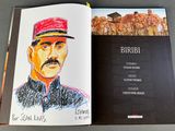 an open book with a drawing of a man in a red hat