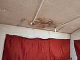 two red curtains hanging from the ceiling of a room