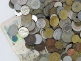 a pile of coins sitting on top of a white table