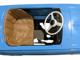 a small blue car with a steering wheel and a paper bag in the passenger seat