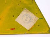 a piece of yellow metal that has a sticker on it