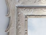 a mirror that is hanging on the wall in the room
