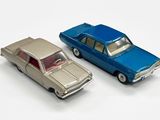 deux voitures jouets assises l'une à côté de l'autre sur une surface blanche