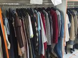 a rack of clothes and shoes in a room