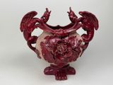 a red vase with a dragon decoration on it