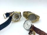 three watches are sitting next to each other on a white surface