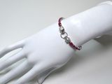 silver bracelet with garnetts and red stones on a mannequin hand
