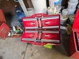 two red tool boxes sitting next to each other on the floor