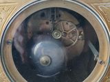 a close up of a clock on a wooden table