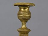 an antique brass candle holder with a decorative design on the top