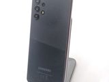 a picture of a black samsung phone on a stand