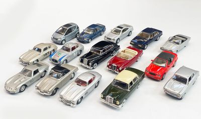 a lot of toy cars that are on a white surface