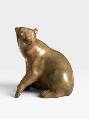 sculpture of a bear sitting on its hind legs on a white surface