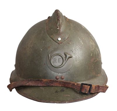 an old military helmet with a leather strap on a white background