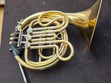 a brass instrument on a black cloth on a table