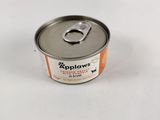 une boîte de conserve ouverte posée sur une table blanche