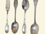 four spoons and a fork on a white background