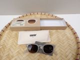 a pair of sunglasses sitting on a table next to a box