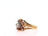 a close up of a gold ring with a flower design