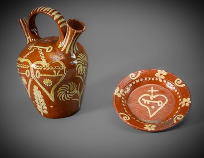 two vases with designs on them sitting next to each other