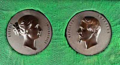 two commemorative medals of the queen and prince of england on a green cloth