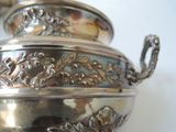 a silver pot that is sitting on a table