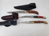 four different types of knives are lined up on a white surface