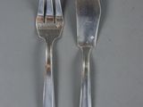 two forks and a knife on a table