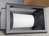 a toilet paper dispenser in a box on the floor