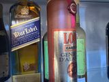 several bottles of liquor are on display in a glass case
