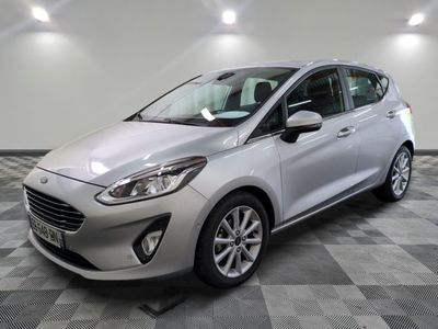 a silver ford fiesta parked on a checkered tile floor