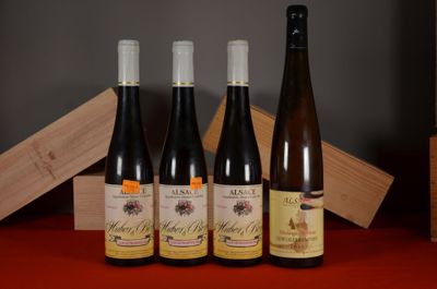 three bottles of wine sit on a table next to a wooden box