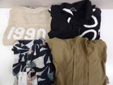 a pile of clothing that is sitting on a shelf