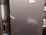 an image of a stainless steel refrigerator with stickers on it