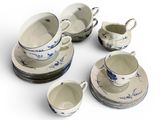 a lot of cups and saucers that are sitting on a table