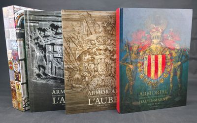 three books are stacked on top of each other on a table