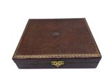 a brown leather box with gold trimming and brass hardware