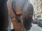 a hand holding up a statue of a baseball glove